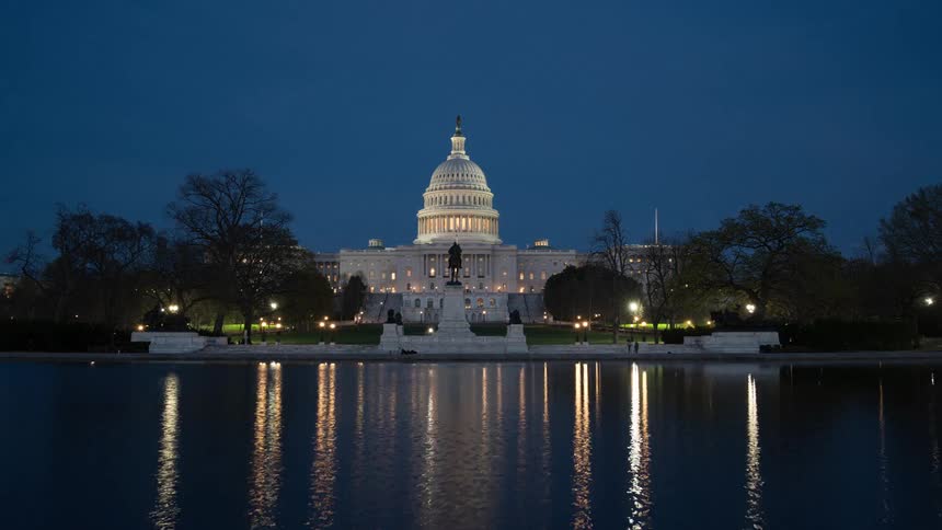 Time lapse of the us capitol building lighting up at night