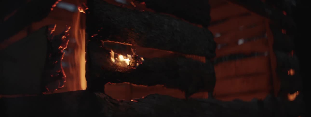 A rickety structure burns at night
