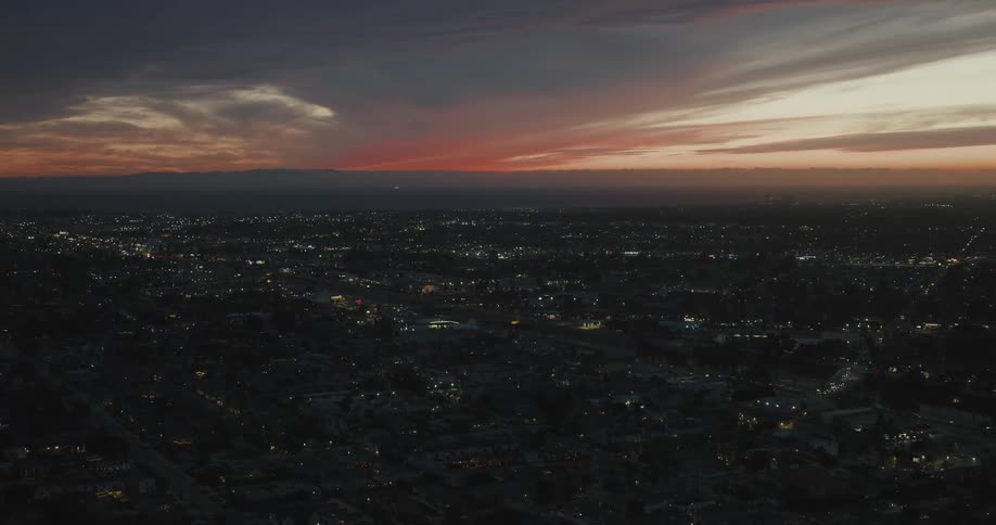 Aerial view of a city under a colorful sunset