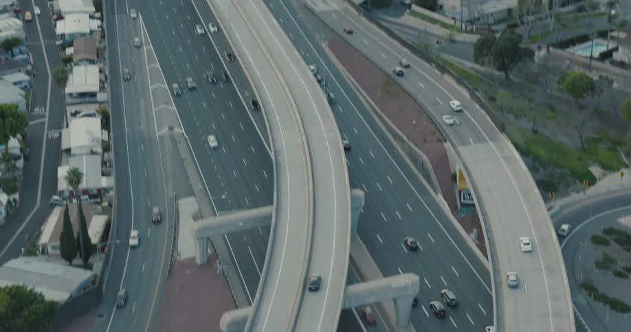 Aerial view of vehicles driving on a highway through the city