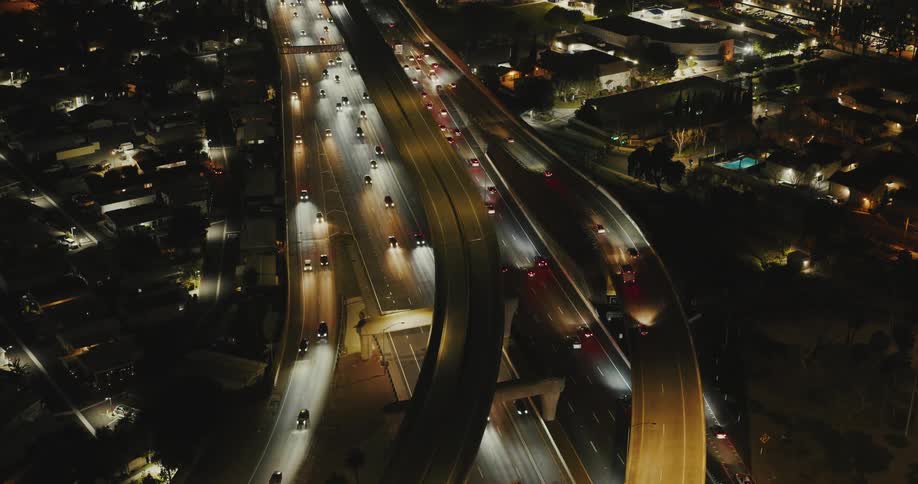 Panorama of an extensive highway with overpasses and vehicle traffic at night