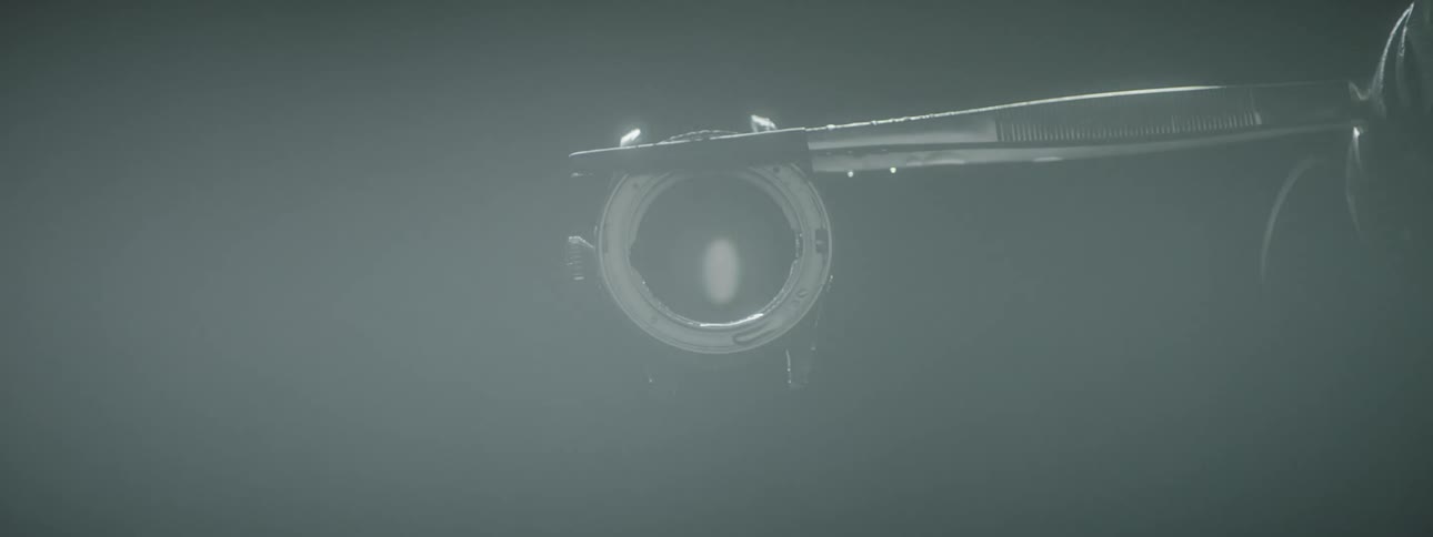 A metal ring being turned by a pair of tweezers
