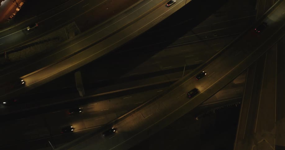 Aerial view of intersections and overpasses with vehicle traffic at night