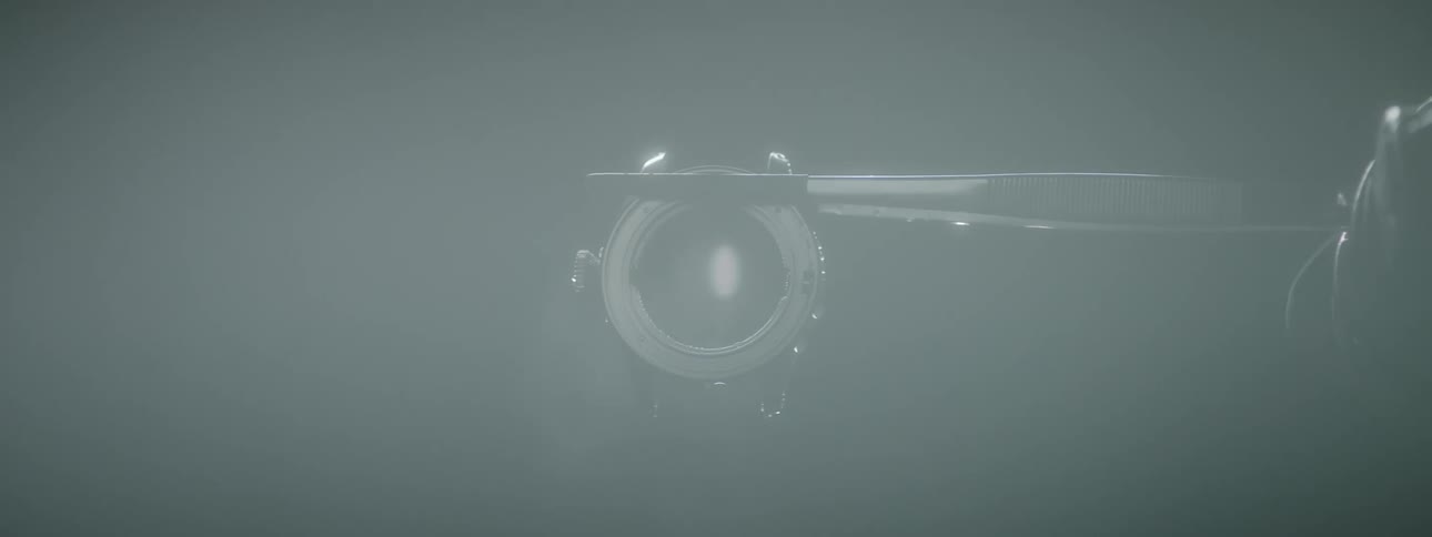 A watch face is meticulously adjusted while being held with tweezers and then steam cleaned