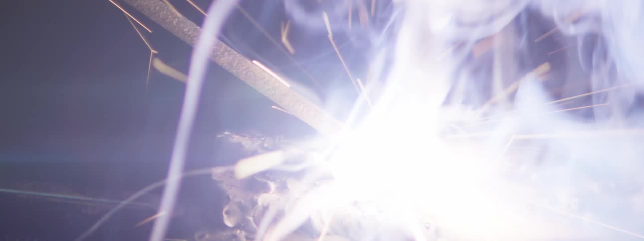 A close up of sparks flying of metal being welded