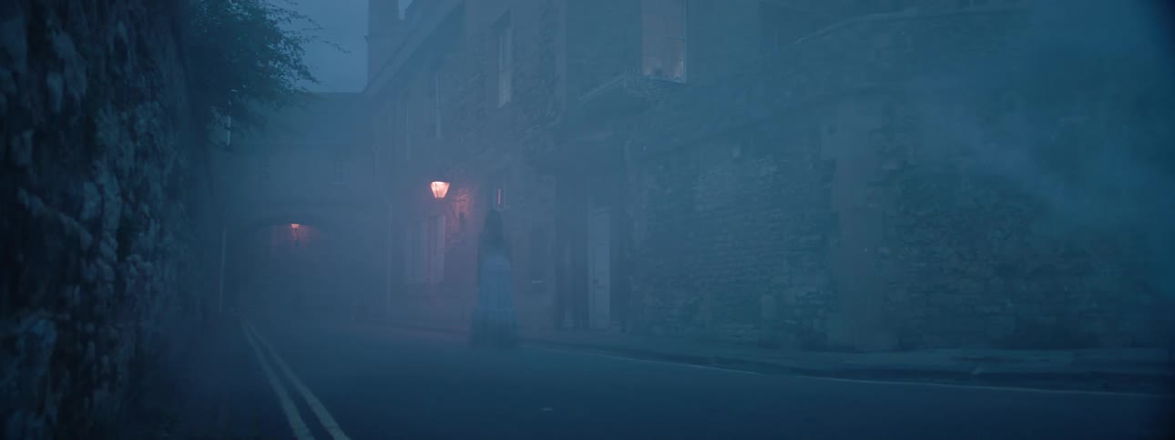 Fog obscures buildings and a street