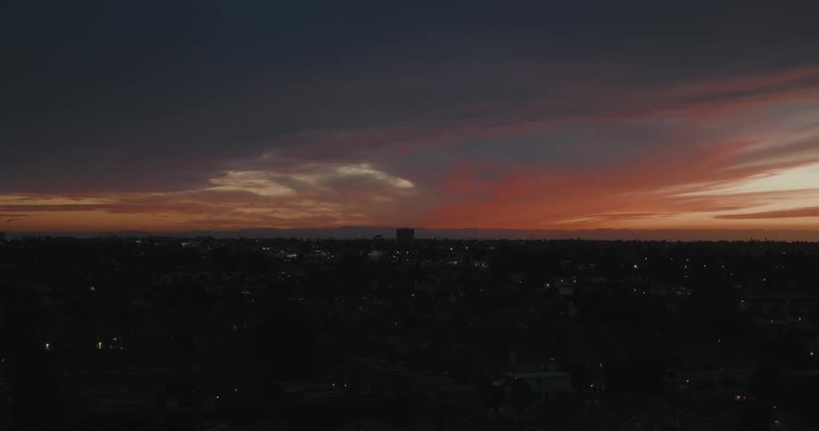 Panorama of an urban city on a reddish sky at dawn