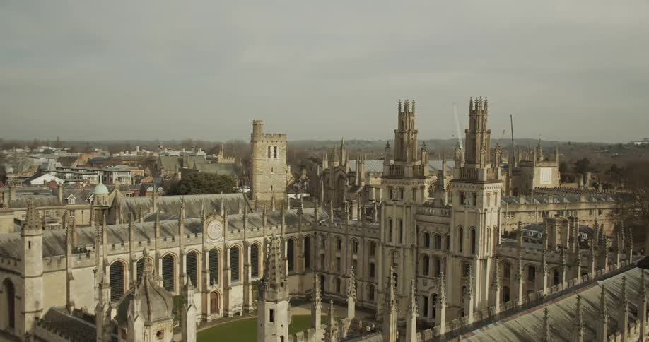 Panorama of a historic building on a square with archaic towers and a city on the horizon