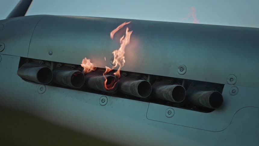 Fire shoots out of the engine on the plane