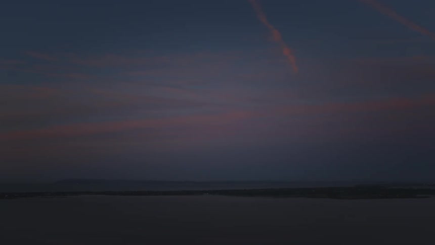 A dark sky with small orange colors in the morning
