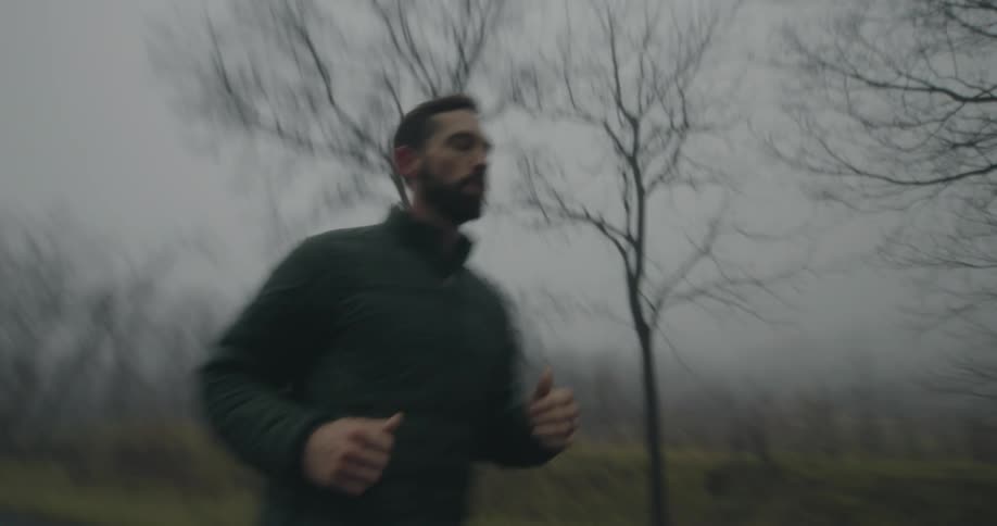 A man runs down a road in a rural area