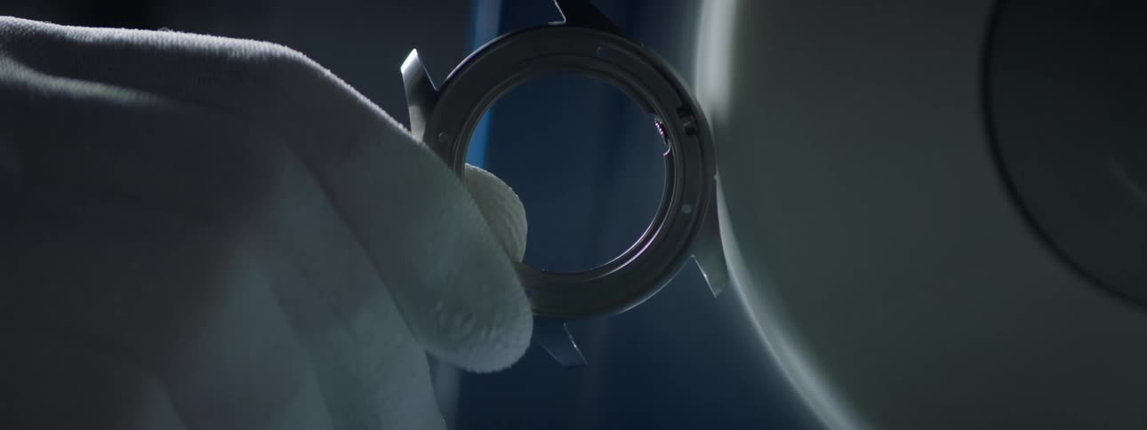 Close up of a gloved hand polishing a wristwatch piece