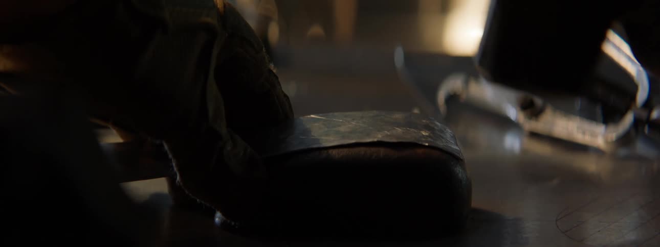 Close up of a person shaping a piece of metal with a hammer