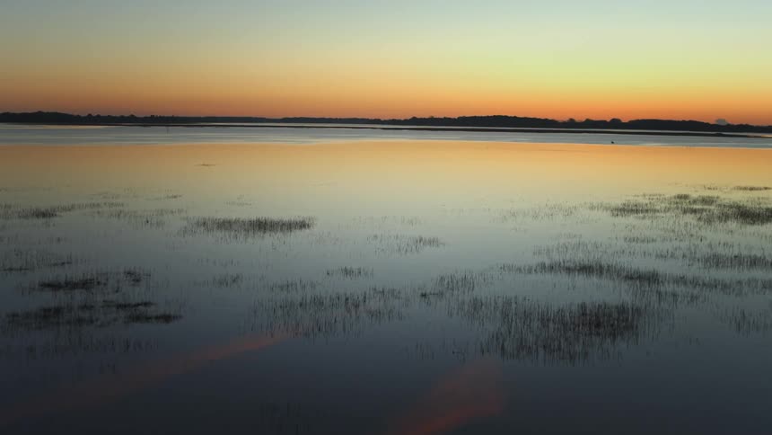 Aerial view of the sunset over a calm lake