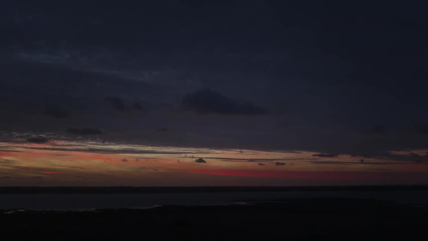 The beach is dark at sunset