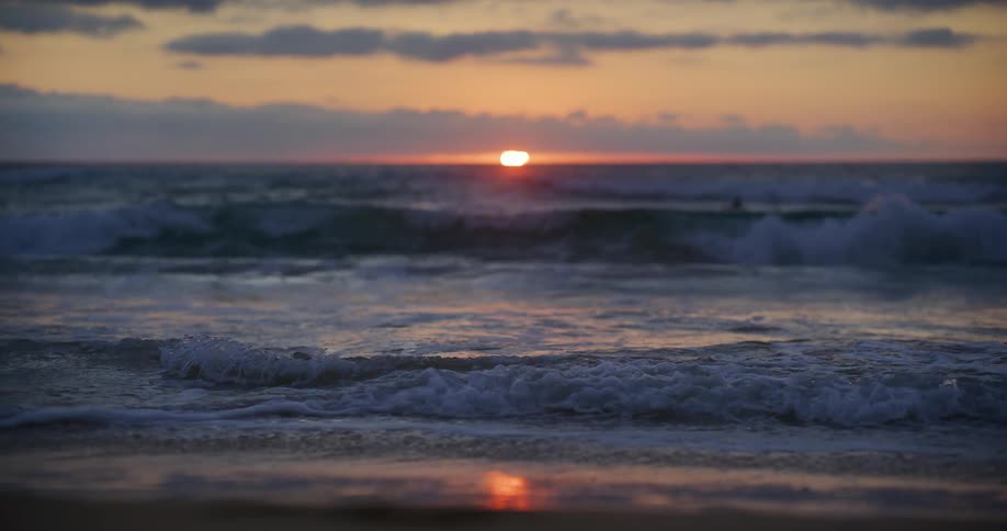 The sun is rising on the beach