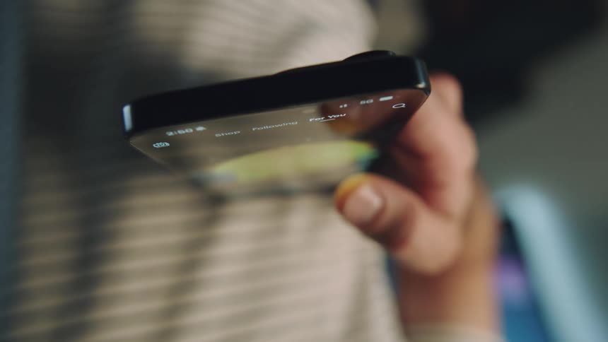 Spinning close up of a person holding a smartphone