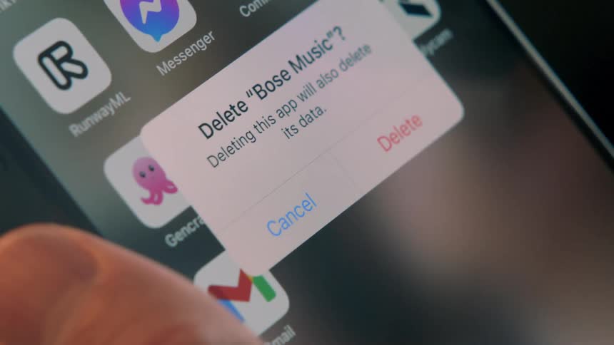 A person opens and removes an app on a smartphone