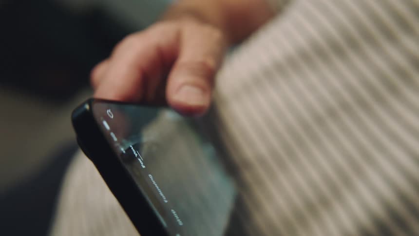 A person swipes on his smartphone