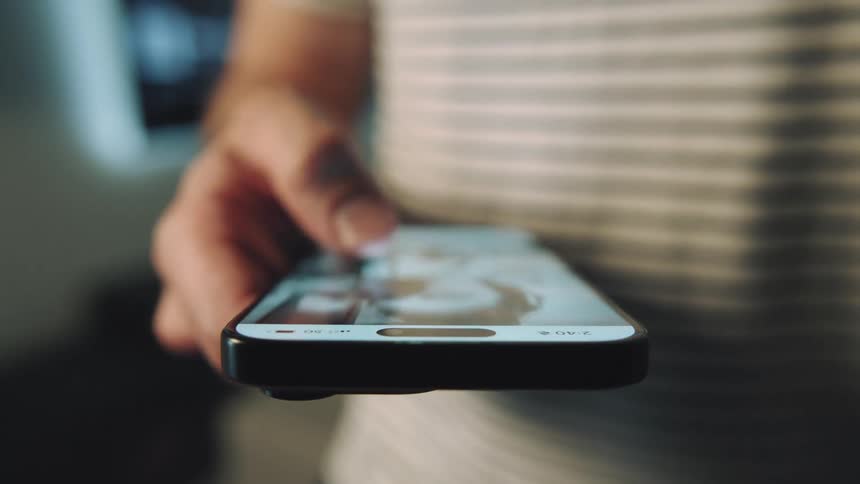 A man swipes on his smartphone