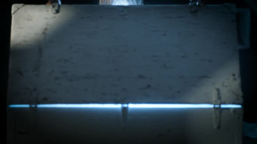 Girl opening a box and a bright light emerges