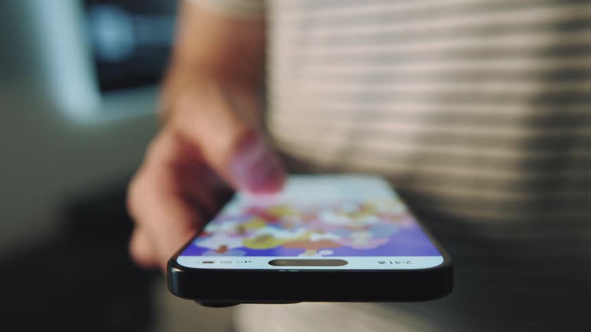 A person browsing videos on a cell phone