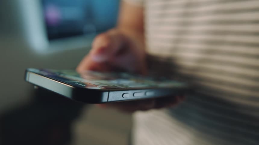 A person is scrolling through their cell phone