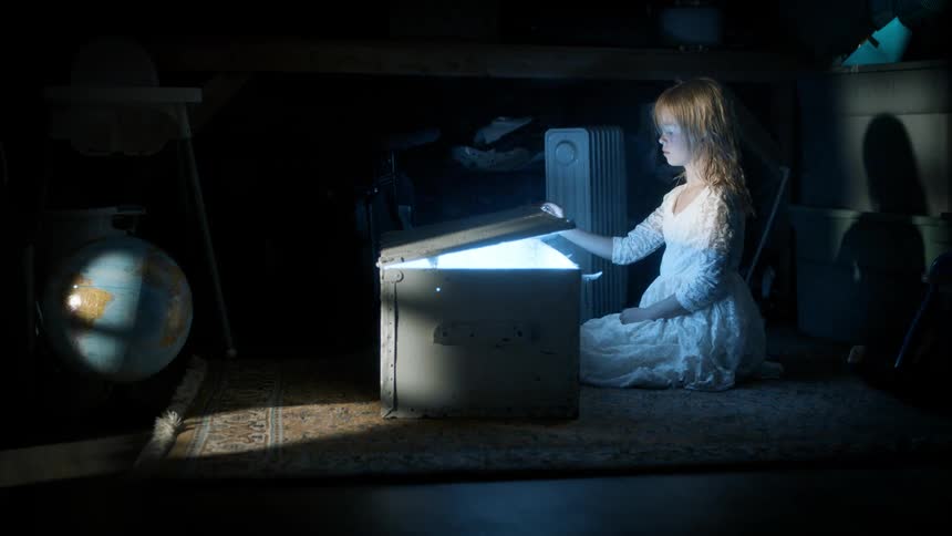 A child opens a chest full of light