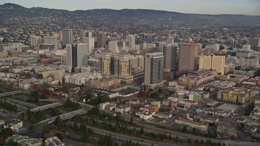 Aerial panorama of a metropolis with residential and commercial buildings and mountains on the horizon