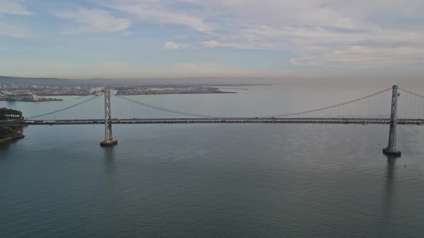Aerial view of a suspension bridge next to a city