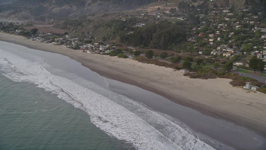 An aerial view of waves crashing on a beach