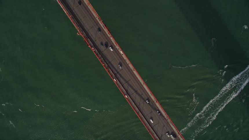 An aerial view of a bridge with six lanes for cars and trucks