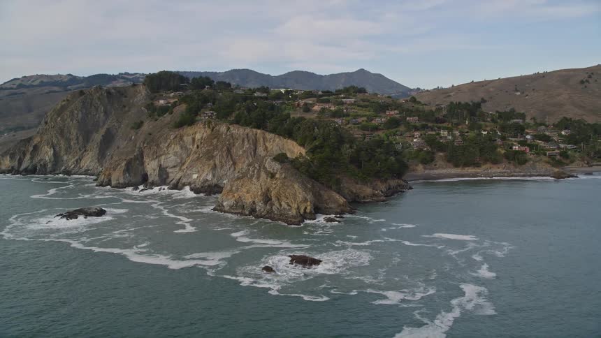 A rural community on a hillside next to a coast