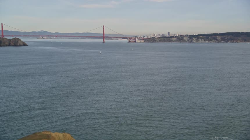 Aerial view of a light house next to the golden gate bridge