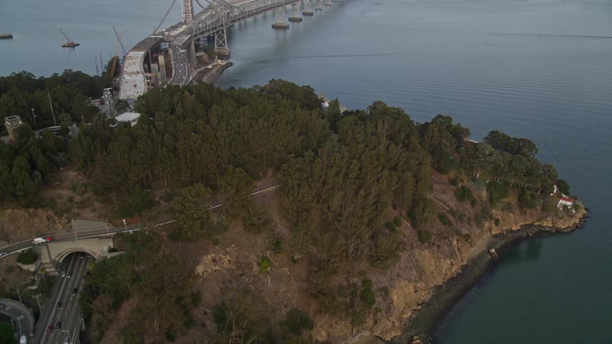 Traffic moves through a tunnel to cross a bridge