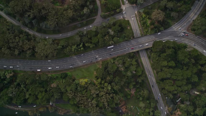 Roads filled with traffic by forests and lakes