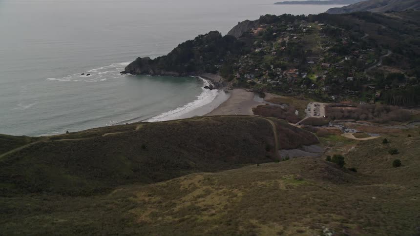 Aerial view of the beach next to a small coastal town