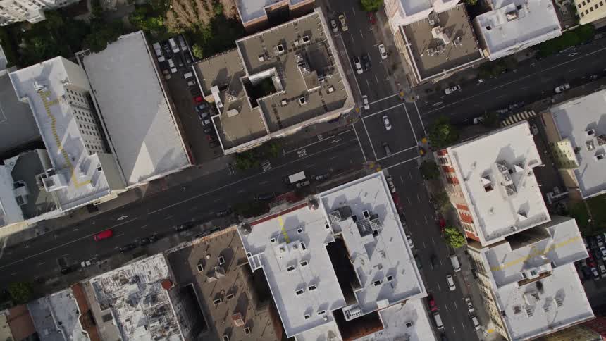 Cars travel through intersections in the city