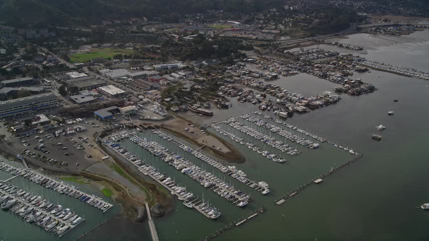 A san francisco marina with rows of sailboats and yachts docked