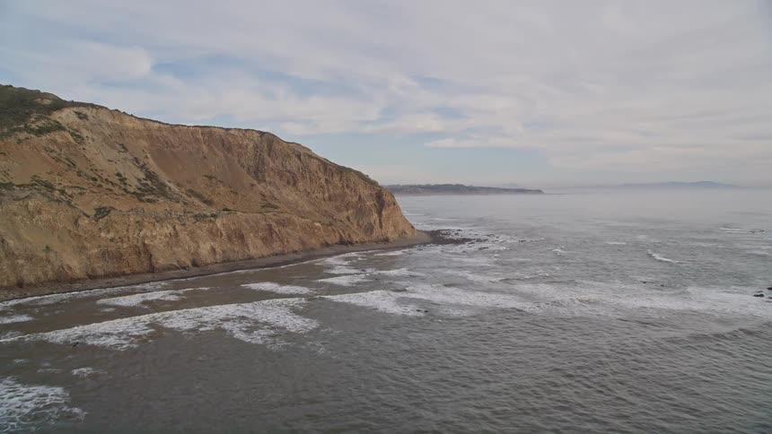 Aerial view of a mountainous landscape next to the ocean
