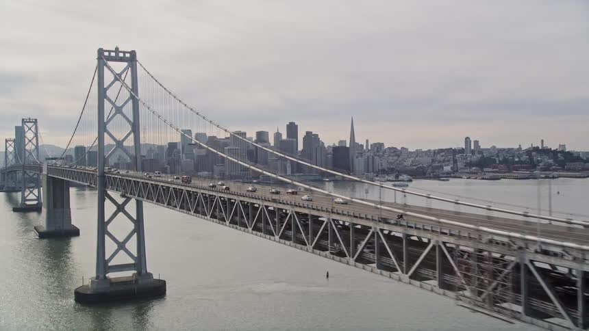 Cars travel on the bridge towards the city