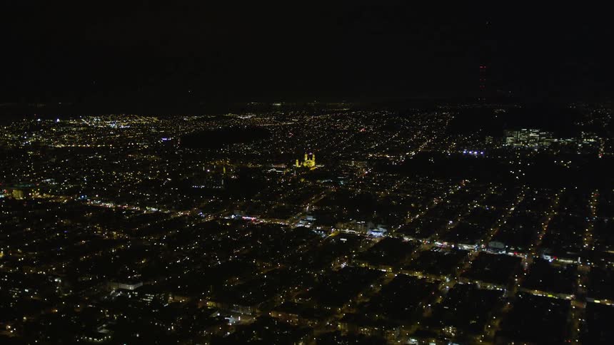 Aerial scene of a metropolis illuminated at night with skyscrapers