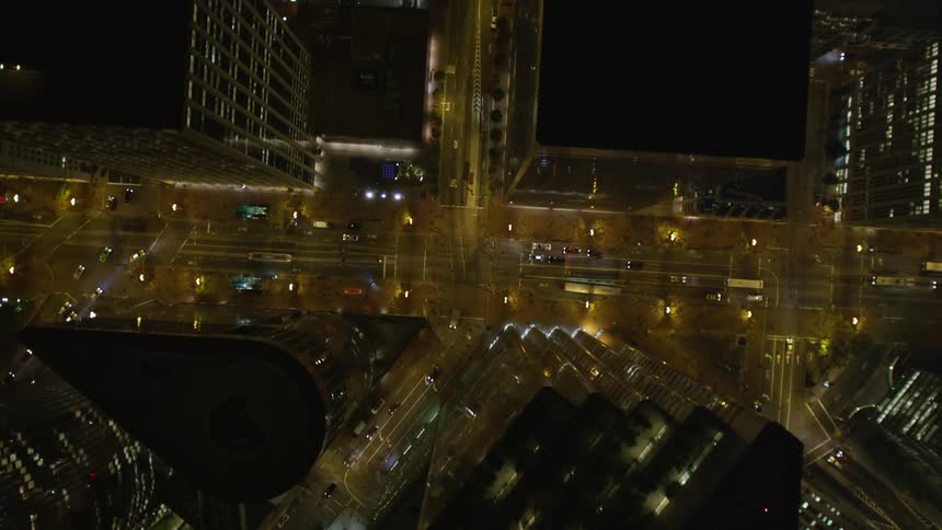 Aerial panorama of a metropolis with skyscrapers and intersections with vehicle traffic at night