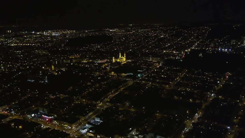 An aerial view of a city with lights at night