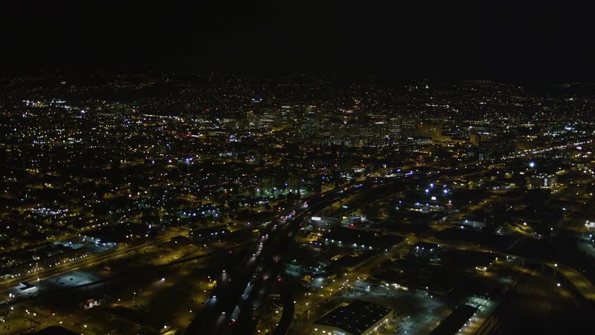 Traffic moves down major city arteries at night