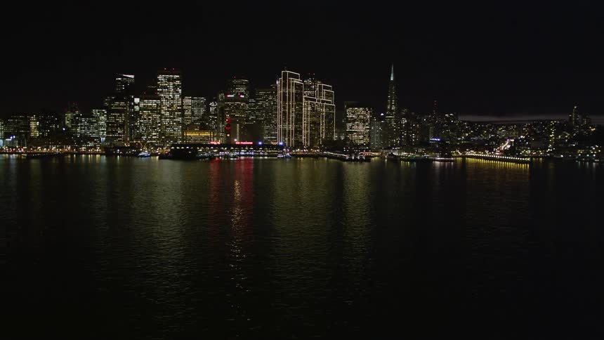 The skyline is brightly lit at night