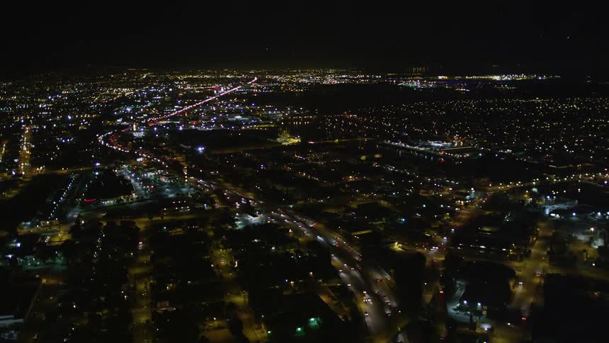Lines of traffic fill the roads in a city at night