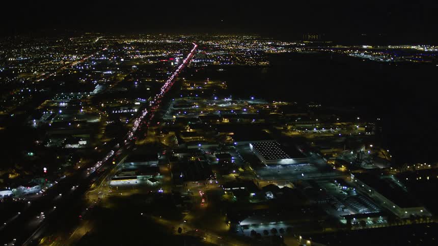 Aerial panorama of a highway in the center of a metropolis at night with vehicle traffic