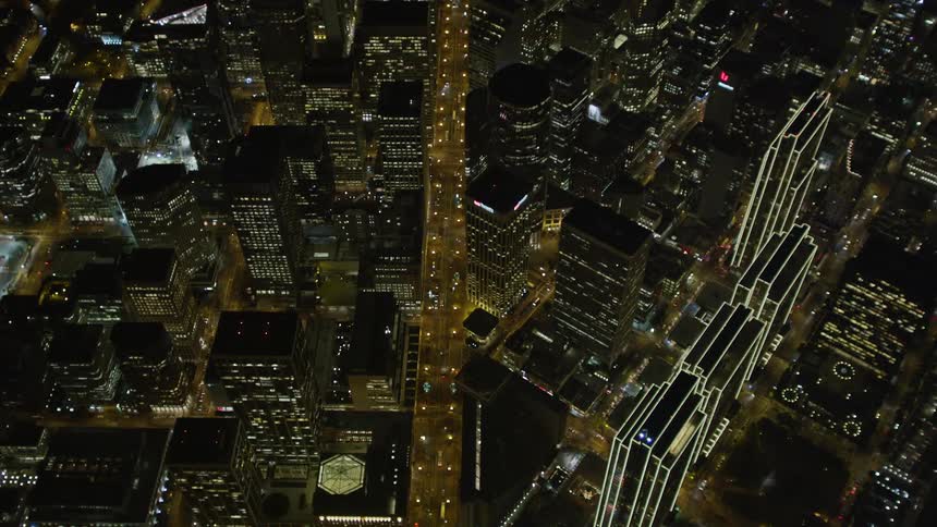 Aerial panorama of a metropolis with skyscrapers and intersections with vehicle traffic at night