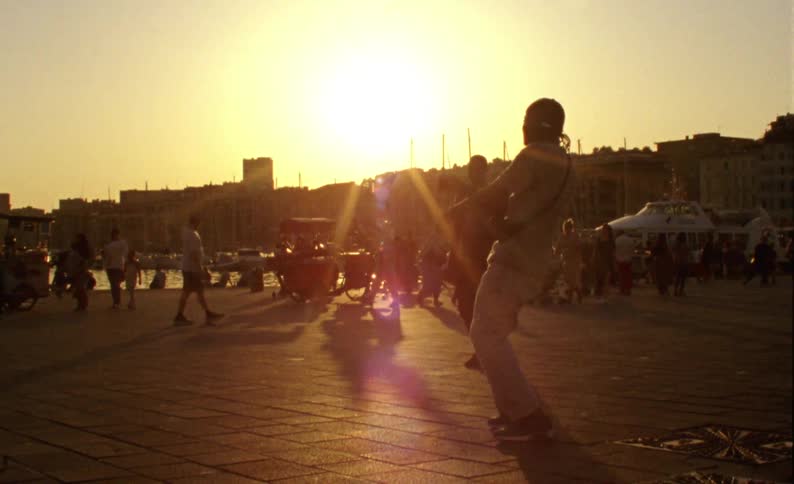 People kick around a soccer ball having fun